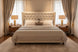 Brown Madri nightstand with poplar top and minimalist modern design, flanking a bed.