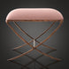 Surya Misho ottoman with a metallic copper finish X-frame base and a plush, rounded pink polyester cushion.
