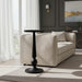 Black aluminum Surya Molino End Table with a pedestal form, 21"H, beside a beige sofa.