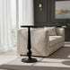 Black aluminum Surya Molino End Table with a pedestal form, 21"H, beside a beige sofa.