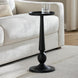 Black aluminum Surya Molino End Table with a pedestal form, 21"H, beside a cream sofa.