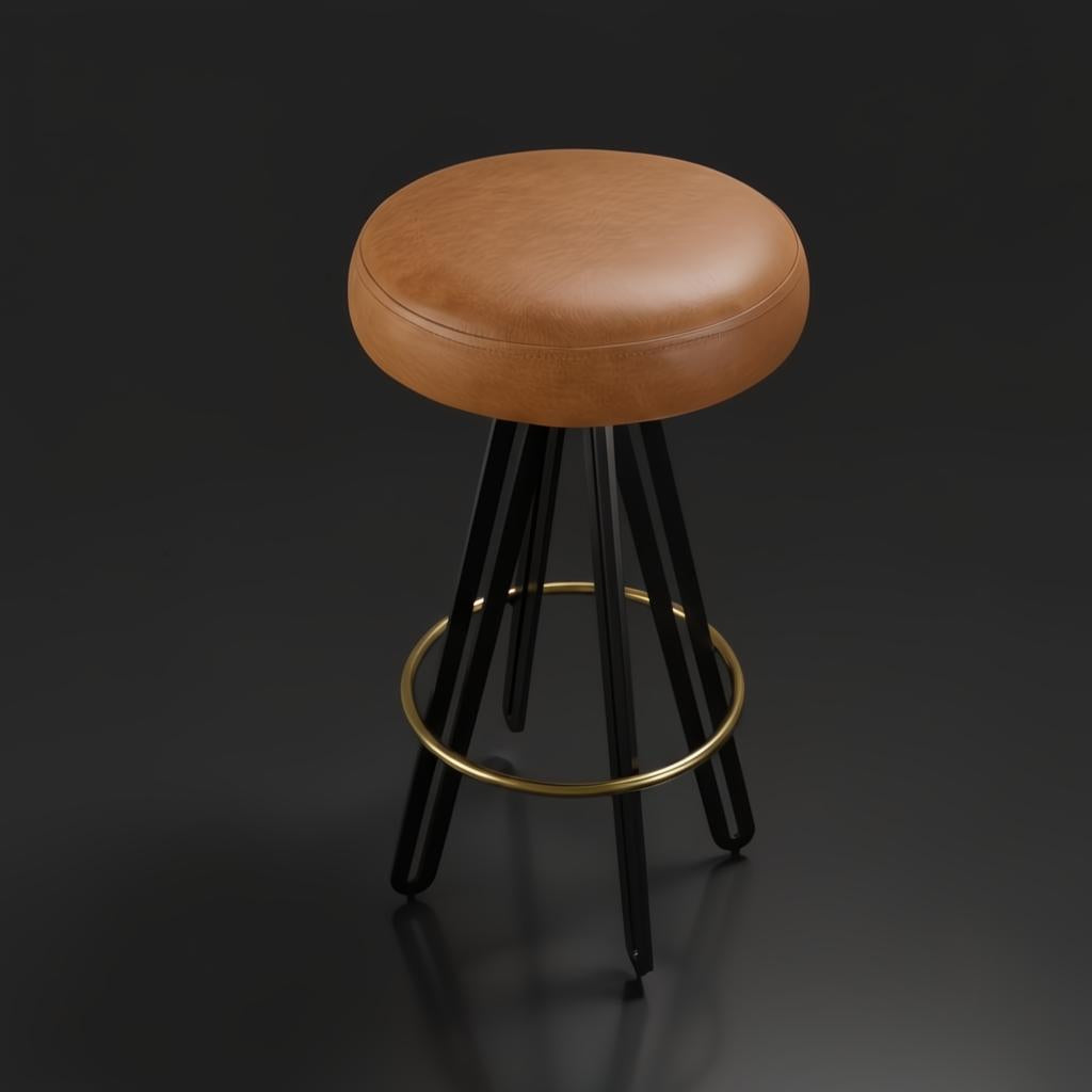 Surya Oberon backless bar stool with brown leather seat, black steel legs, and a brass footrest.