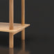 Close-up of a light brown mango wood bookcase shelf with round support posts.