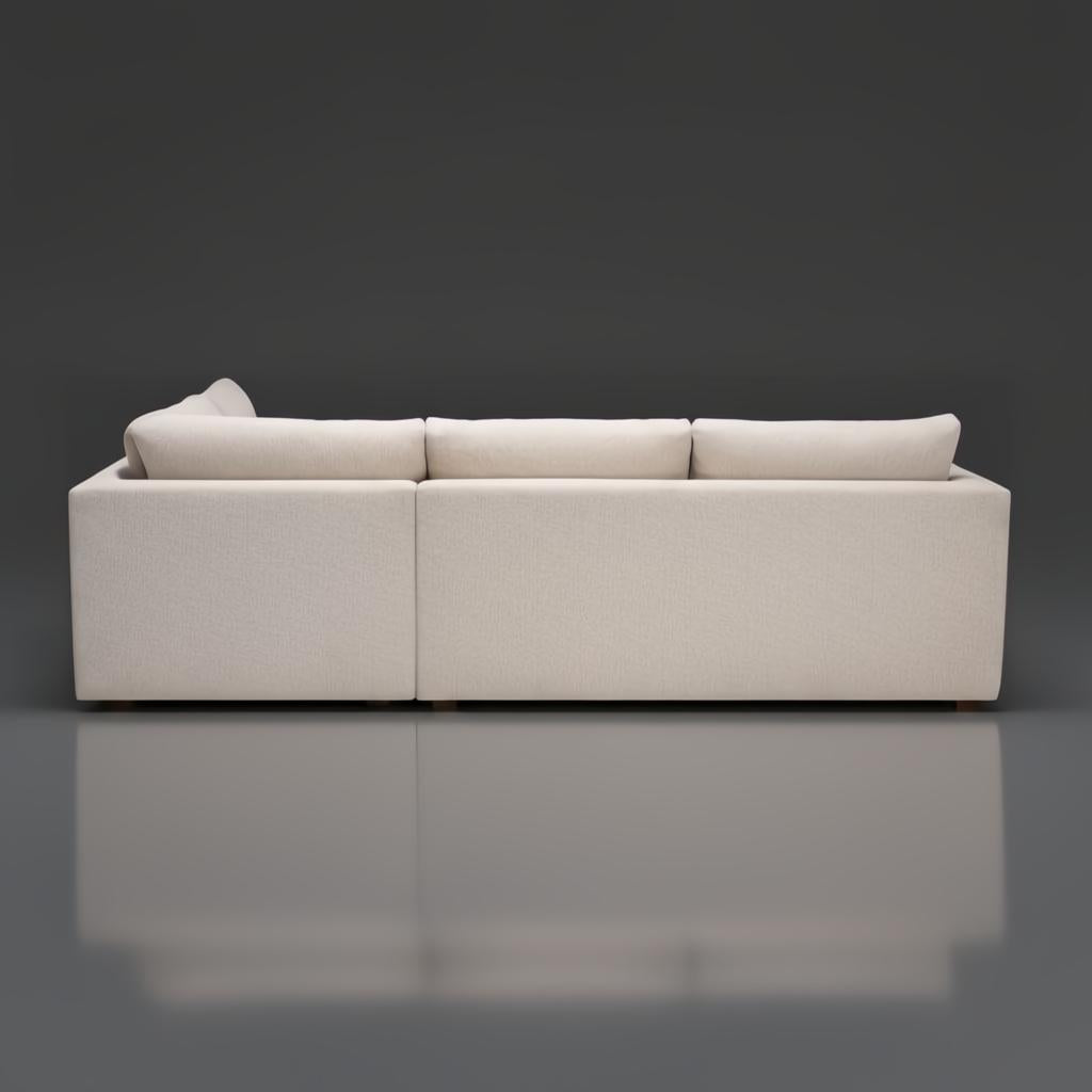 Rear view of a light brown Surya Pedersen Left Arm Facing Sectional with a brown stained poplar base.