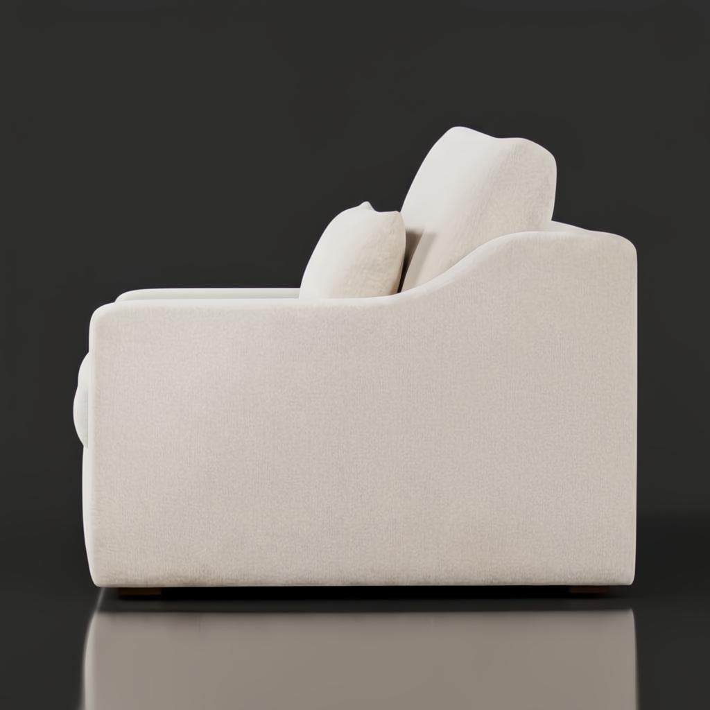 Side view of a light beige polyester sectional sofa with a low profile and a brown stained poplar base.