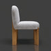 Surya Pico Dining Chair with taupe polyester-linen upholstery and brown rubber wood base, side view.