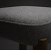 Close-up of a Surya Pico Dining Chair seat, showing taupe polyester and linen fabric upholstery with a textured weave and a glimpse of the brown rubber wood base.