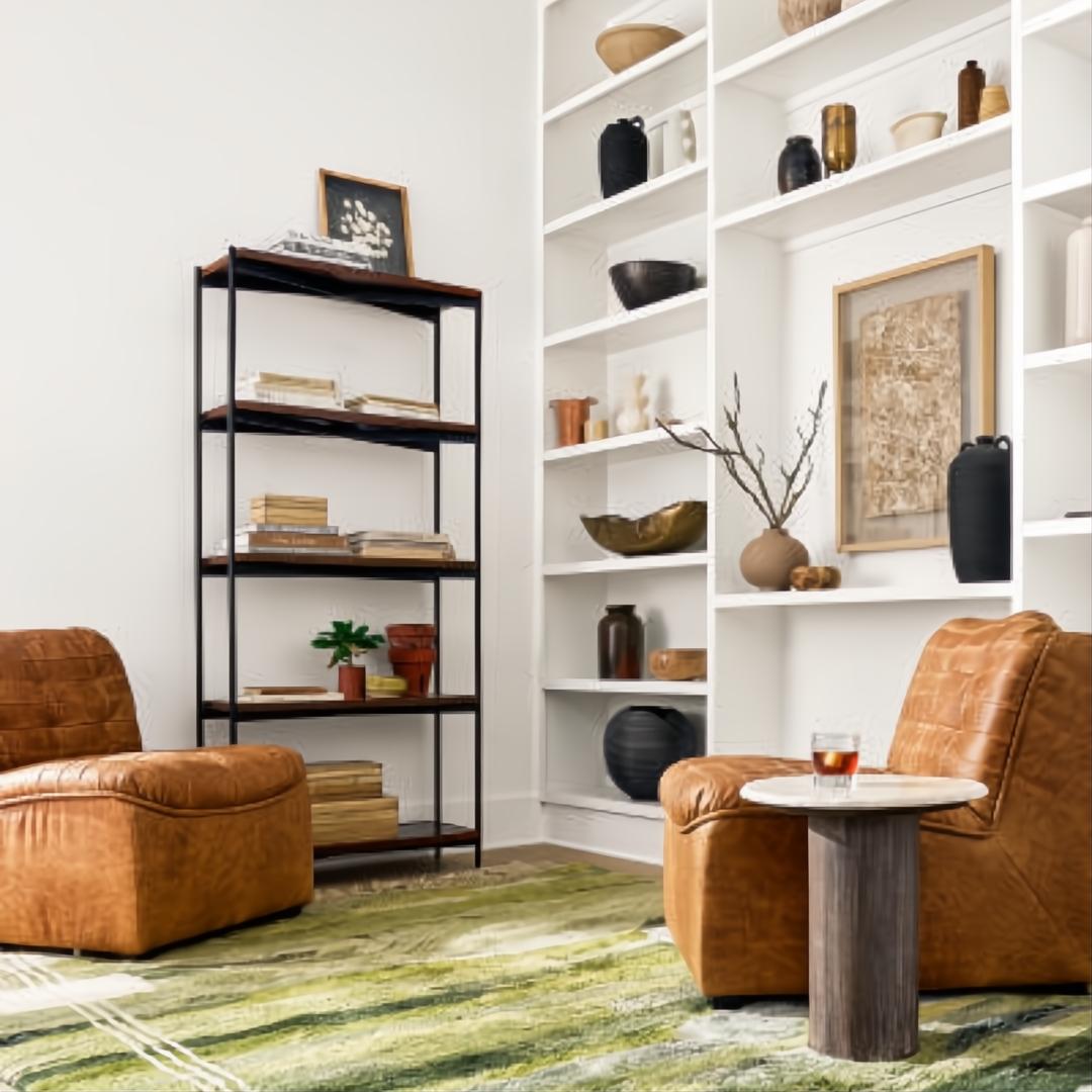 Brown leather modular sofa chairs with black rubber wood bases in a modern living room.