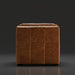 Surya Oryan modular sofa in brown leather with a black rubber wood base, featuring a tufted design.