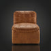 Surya Oryan modular chair with brown leather upholstery, tufted cushions, and a black rubber wood base.