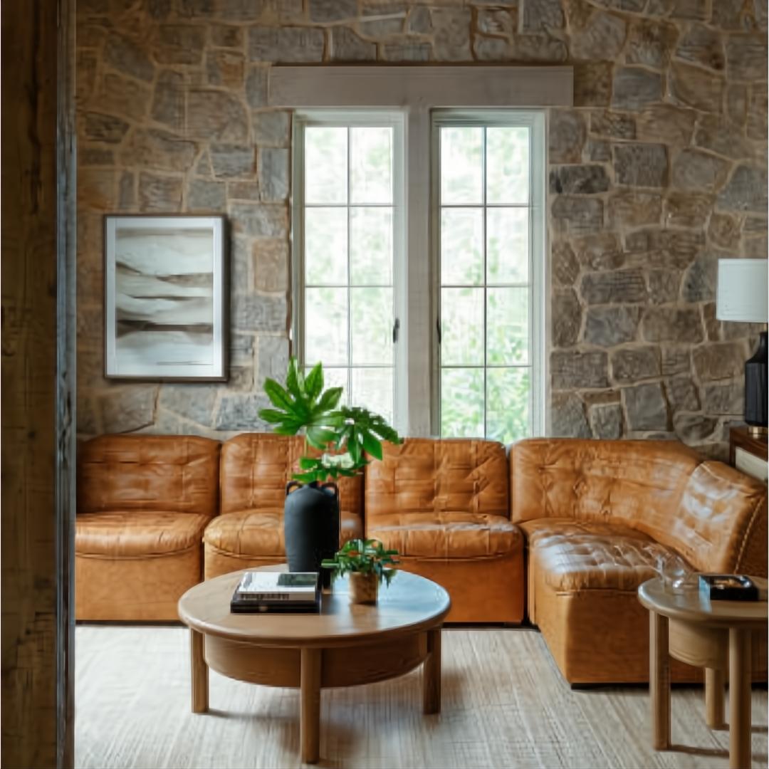 Surya Oryan modular sofa in brown leather with a black rubber wood base, arranged in an L-shape.
