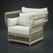 Cream Surya Winder accent chair with woven frame, Sunbrella cushions, and three pillows.