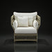 Surya Winder accent chair with cream Sunbrella cushions and a woven beige frame.